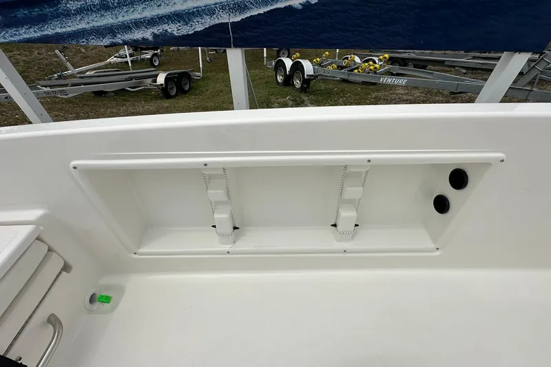 Slide: The Image of 2026 Bayliner Trophy T18 boat interior detail with storage compartment and cup holders. - 35