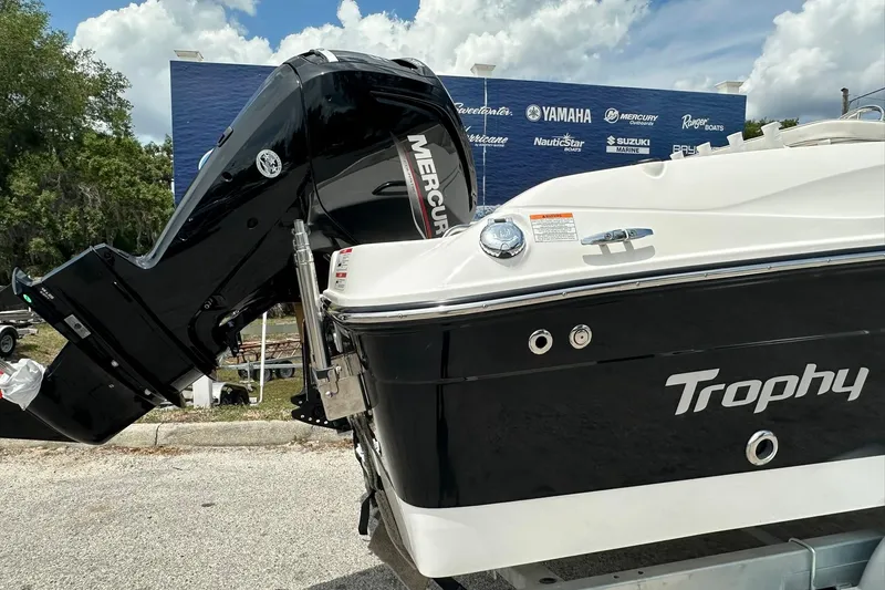 Slide: The Image of 2026 Bayliner Trophy T18 boat with Mercury outboard motor, parked outdoors. - 36