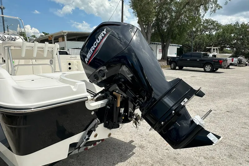 Slide: The Image of 2026 Bayliner Trophy T18 boat with Mercury outboard motor in a parking lot. - 39