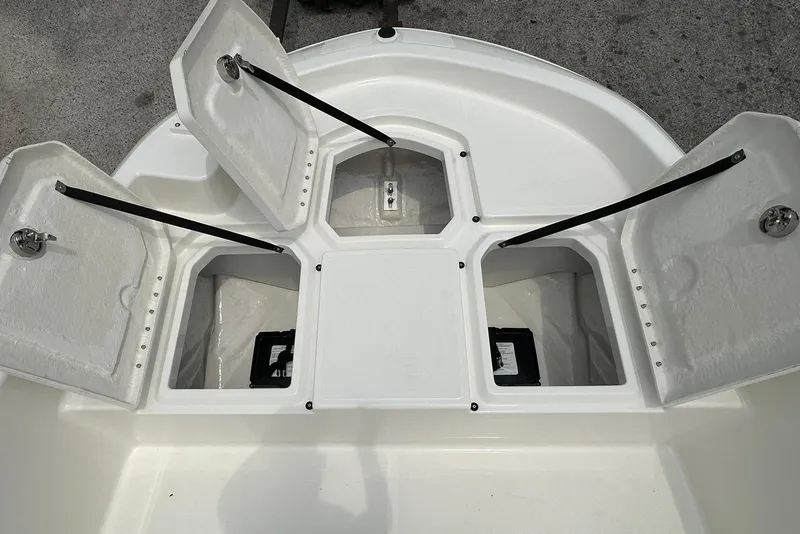 Slide: The Image of 2026 Bayliner Trophy T18 boat storage compartments open, showcasing interior design. - 7