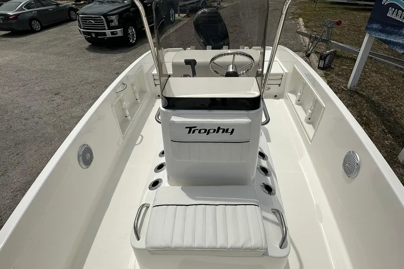 Slide: The Image of 2026 Bayliner Trophy T18 boat interior with steering console and seating. - 8