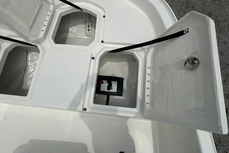 Slide: The Image of Open storage compartments on a 2026 Bayliner Trophy T18 boat deck. - 9