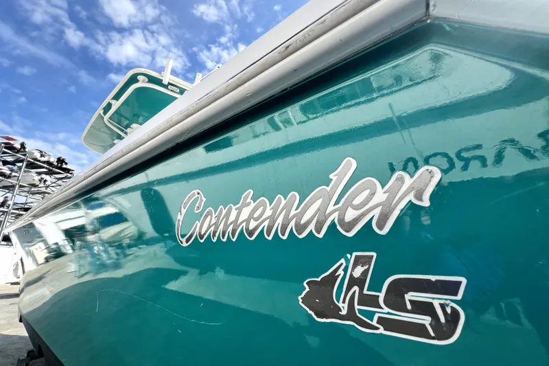 Slide: The Image of 2012 Contender 35 LS boat with logo, under a clear blue sky. - 22