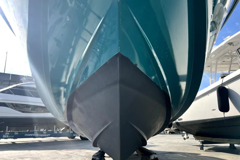Slide: The Image of 2012 Contender 35 LS boat hull in dry dock, showcasing sleek design and craftsmanship. - 26