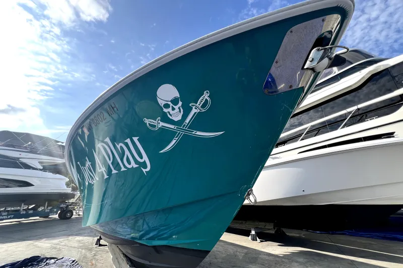 Slide: The Image of 2012 Contender 35 LS boat with pirate-themed graphics, docked under a blue sky. - 28