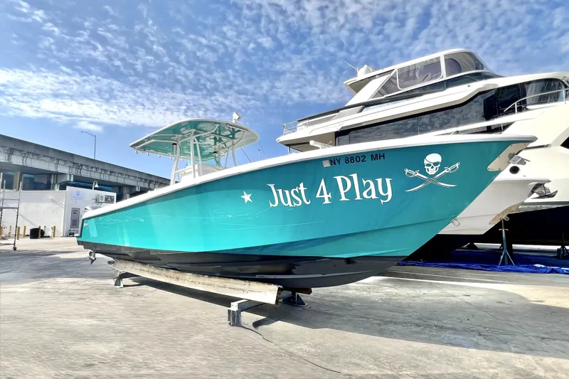 Slide: The Image of 2012 Contender 35 LS boat named "Just 4 Play" on a sunny day. - 29