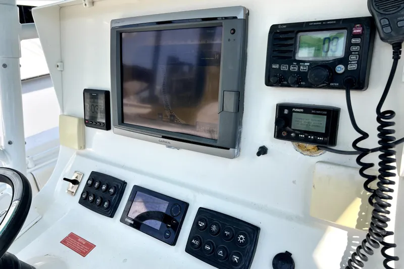 Slide: The Image of Control panel of a 2012 Contender 35 LS boat with navigation and communication equipment. - 39