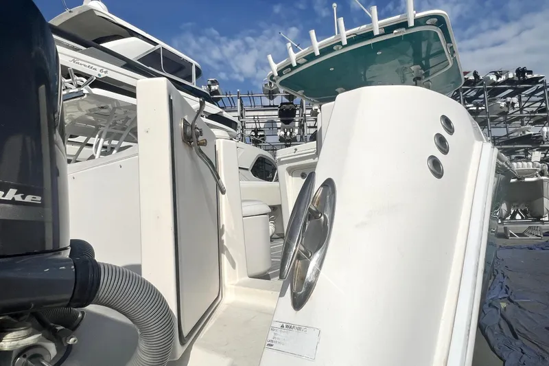 Slide: The Image of 2012 Contender 35 LS boat docked, showcasing sleek design and powerful engine. - 4