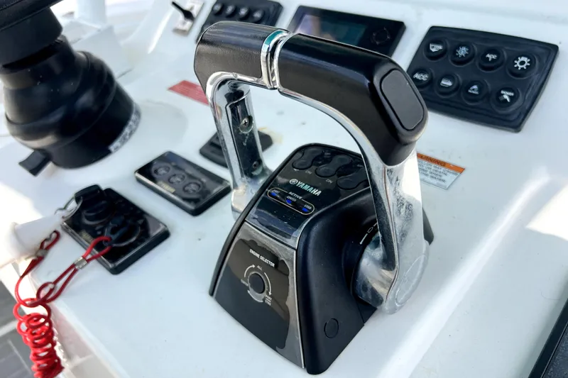 Slide: The Image of Close-up of Yamaha throttle controls on a 2012 Contender 35 LS boat dashboard. - 43