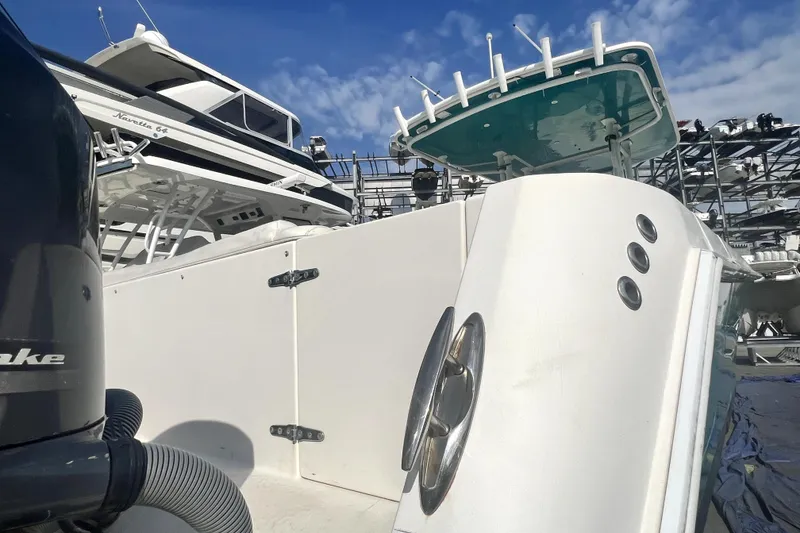 Slide: The Image of 2012 Contender 35 LS boat docked, showcasing sleek design and powerful engine. - 5