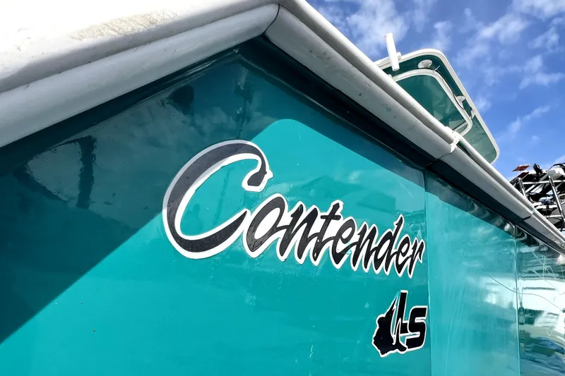 Slide: The Image of Teal Contender 35 LS boat from 2012 under a clear blue sky. - 6