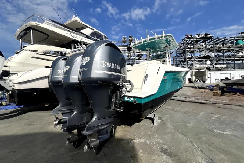 Slide: The Image of 2012 Contender 35 LS boat with Yamaha engines in a marina setting. - 8