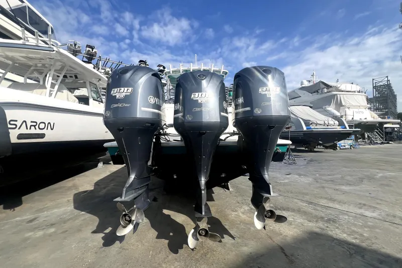 Slide: The Image of Triple Yamaha outboard engines on a 2012 Contender 35 LS boat in a marina. - 9