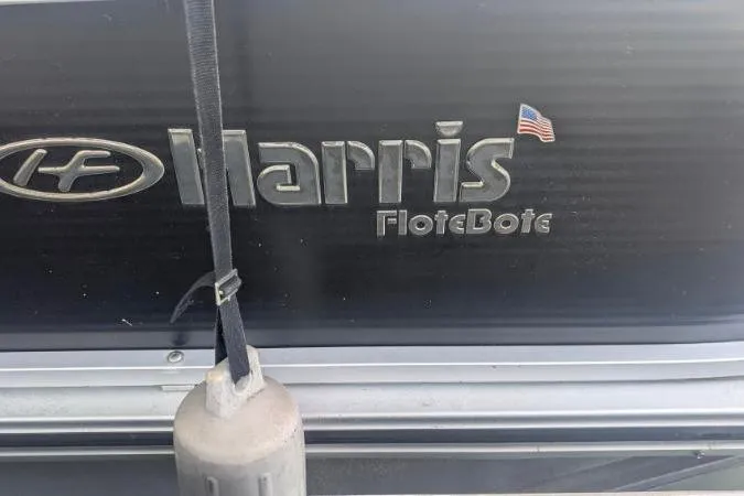 Slide: The Image of 2012 Harris FloteBote 230 Grand Mariner SEL logo with American flag detail. - 11