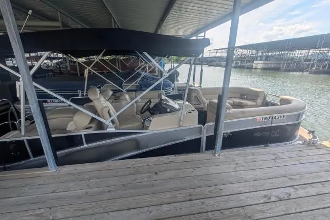 Slide: The Image of 2012 Harris FloteBote 230 Grand Mariner SEL pontoon boat docked under a covered marina. - 14