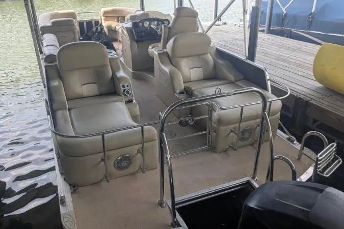 Slide: The Image of 2012 Harris FloteBote 230 Grand Mariner SEL pontoon boat with beige seating and steering console. - 4