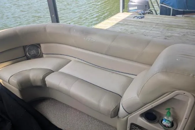 Slide: The Image of 2012 Harris FloteBote 230 Grand Mariner SEL pontoon boat interior with beige seating by the dock. - 8