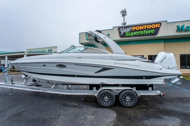 The Image of 2026 Crowline 290 XSS boat on trailer at dealership, overcast day. - 0