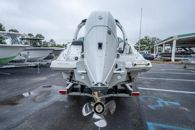Slide: The Image of 2026 Crowline 290 XSS boat rear view in a parking lot, showcasing outboard motor. - 11