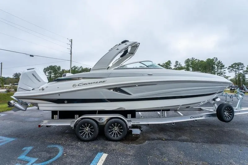 Slide: The Image of 2026 Crowline 290 XSS boat on trailer, parked outdoors. - 3