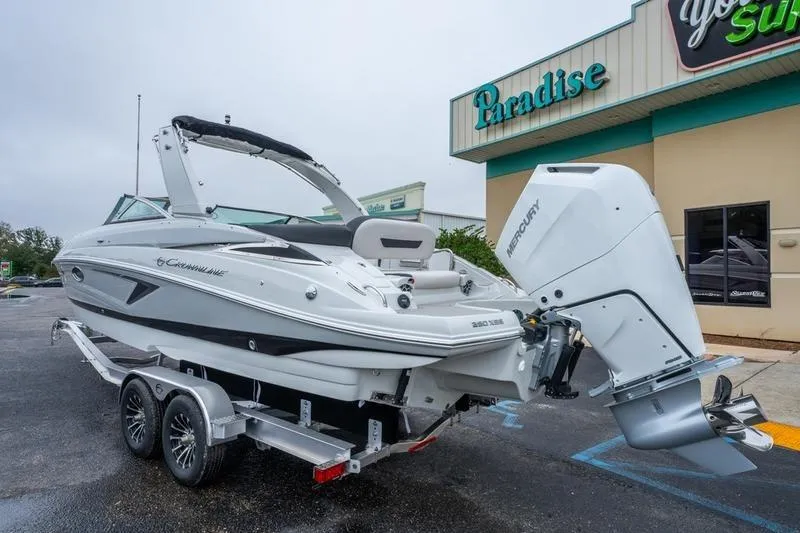 Slide: The Image of 2026 Crowline 290 XSS boat on trailer outside Paradise store. - 5