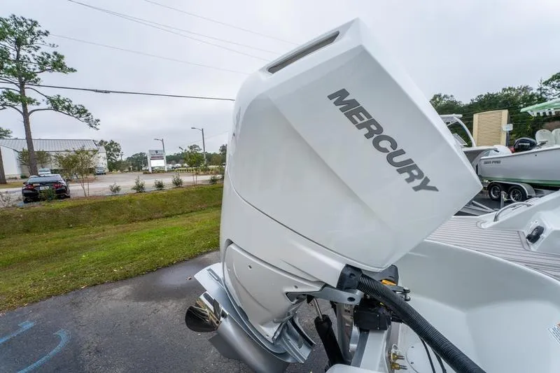 Slide: The Image of 2026 Crowline 290 XSS boat with Mercury outboard motor, parked outdoors. - 8