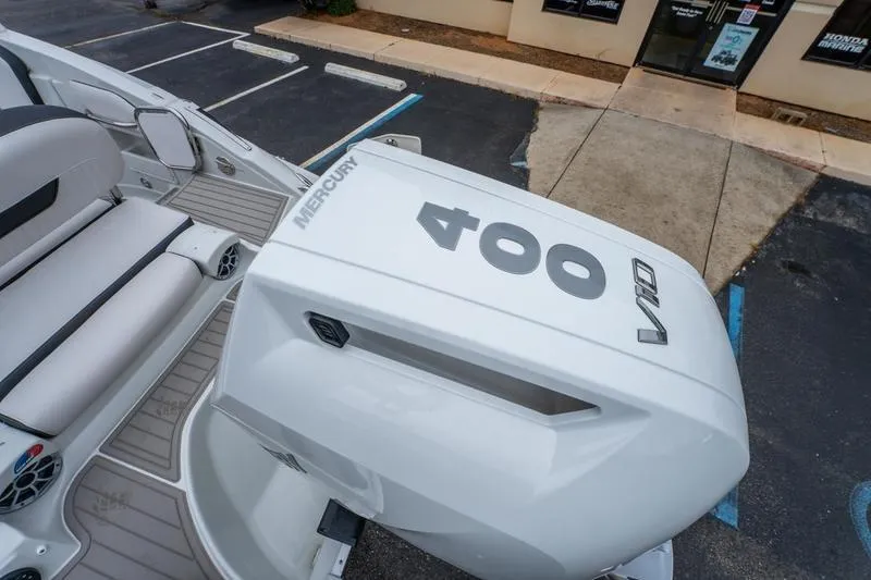 Slide: The Image of 2026 Crowline 290 XSS boat with Mercury 400 V10 engine in parking lot. - 9
