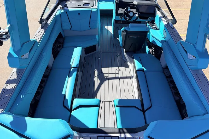 Slide: The Image of 2026 Nautique Super Air Nautique G23 interior with blue seating and modern design. - 12