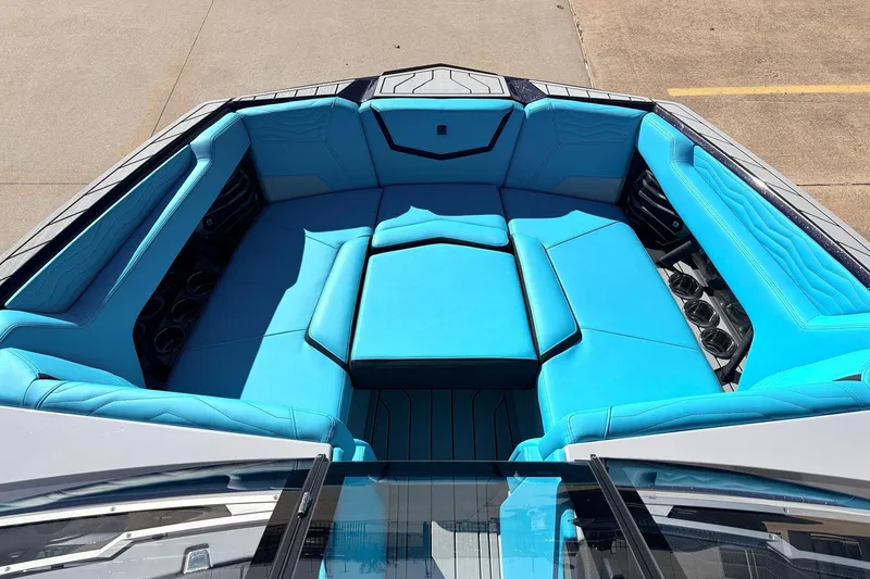 Slide: The Image of 2026 Nautique Super Air Nautique G23 boat interior with vibrant blue seating. - 13