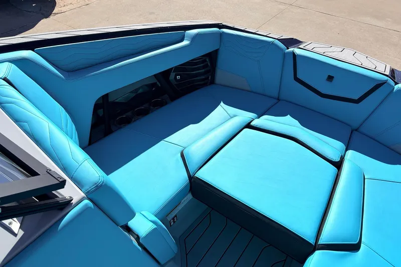 Slide: The Image of 2026 Nautique Super Air Nautique G23 boat interior with vibrant blue seating and cup holders. - 14