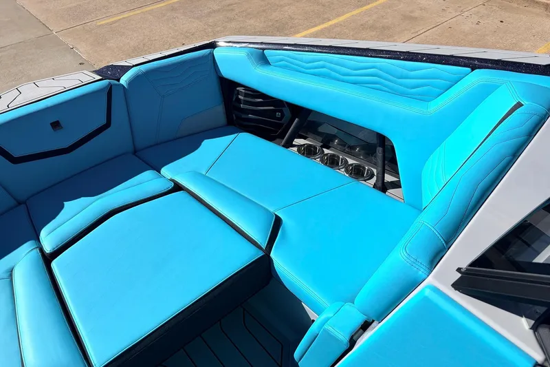 Slide: The Image of 2026 Nautique Super Air Nautique G23 interior with vibrant blue seating and sleek design. - 15