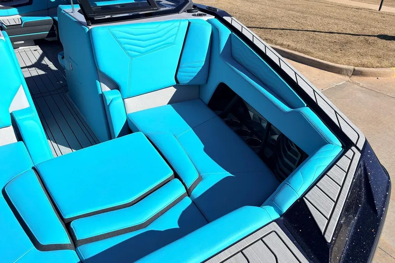 Slide: The Image of 2026 Nautique Super Air Nautique G23 boat interior with vibrant blue seating. - 16