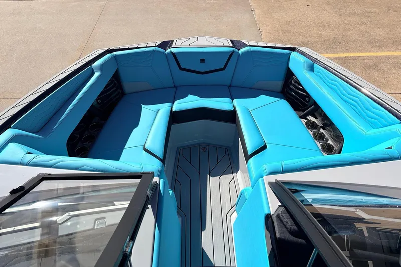 Slide: The Image of 2026 Nautique Super Air Nautique G23 boat interior with vibrant blue seating and sleek design. - 19