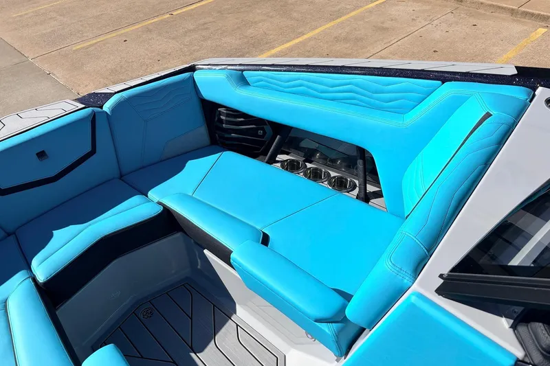 Slide: The Image of 2026 Nautique Super Air Nautique G23 boat interior with vibrant blue seating and sleek design. - 21