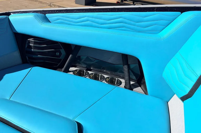 Slide: The Image of Interior of 2026 Nautique Super Air Nautique G23 with blue seating and cup holders. - 23