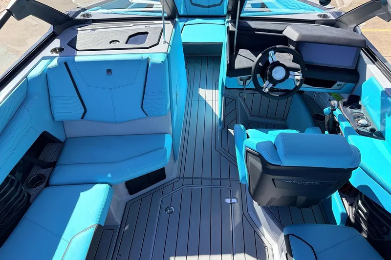 Slide: The Image of 2026 Nautique Super Air Nautique G23 interior with blue seating and modern dashboard design. - 24