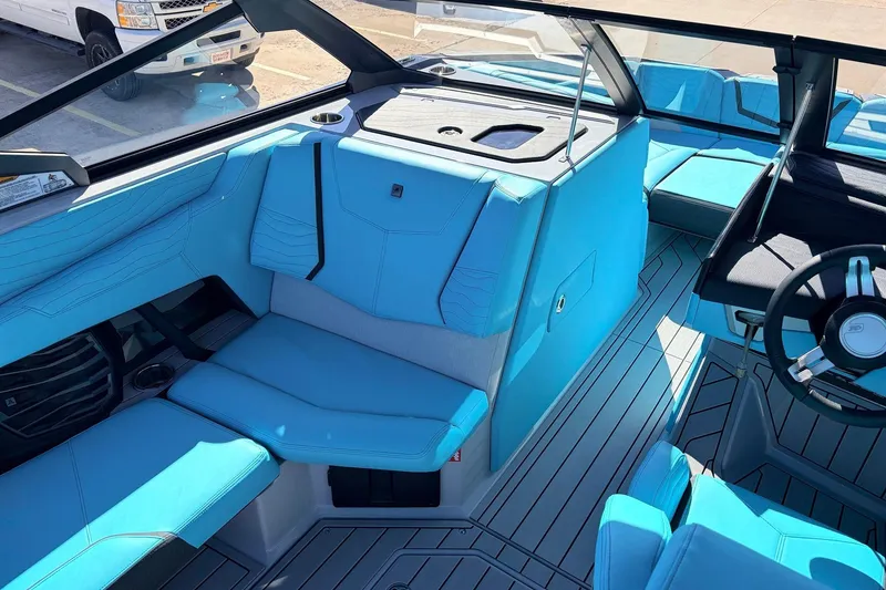 Slide: The Image of 2026 Nautique Super Air Nautique G23 interior with blue seating and modern design. - 25