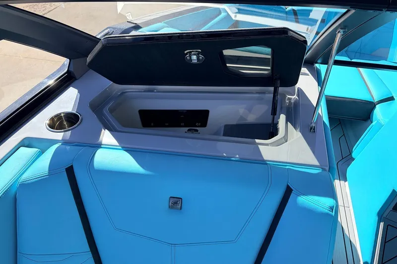 Slide: The Image of 2026 Nautique Super Air Nautique G23 interior with blue seating and storage compartment. - 26