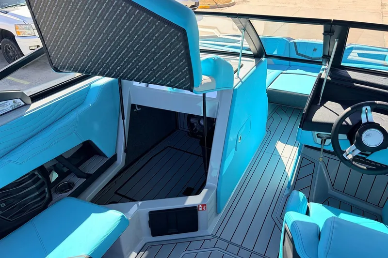 Slide: The Image of Interior of 2026 Nautique Super Air Nautique G23, featuring sleek blue seating and modern design. - 28