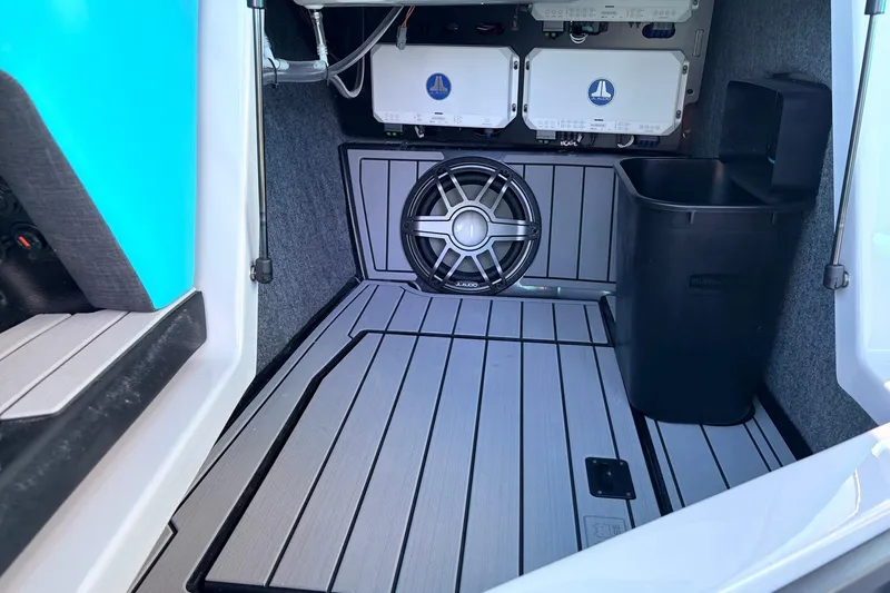 Slide: The Image of 2026 Nautique Super Air Nautique G23 interior with subwoofer and storage compartment. - 29