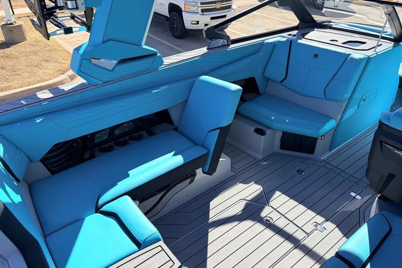 Slide: The Image of Interior of 2026 Nautique Super Air Nautique G23 with blue seating and modern design. - 33