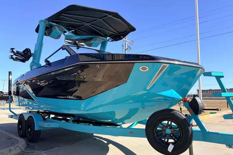 Slide: The Image of 2026 Nautique Super Air Nautique G23 boat in vibrant blue on trailer. - 4