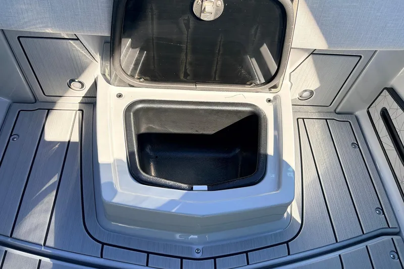 Slide: The Image of Open storage compartment on 2026 Nautique Super Air Nautique G23 boat deck. - 40
