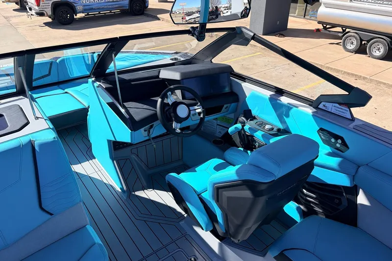 Slide: The Image of 2026 Nautique Super Air Nautique G23 boat interior with modern blue seating and sleek dashboard design. - 44