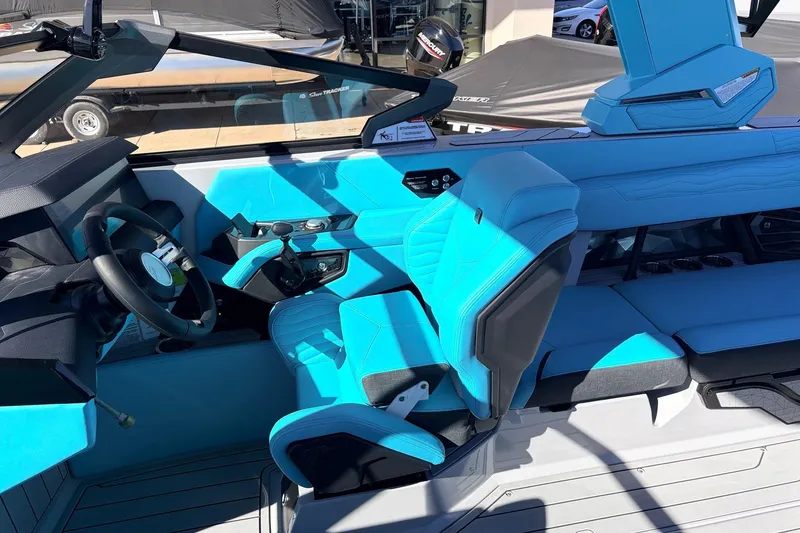 Slide: The Image of Interior of 2026 Nautique Super Air Nautique G23, featuring vibrant blue seating and modern controls. - 46
