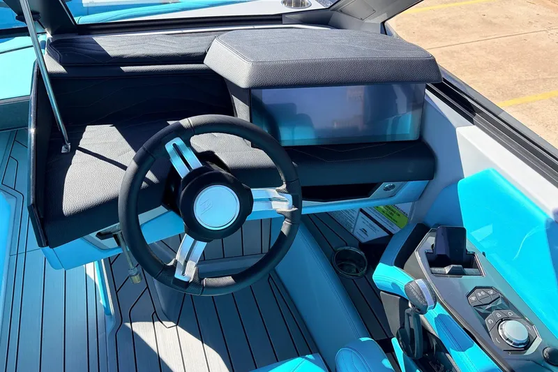 Slide: The Image of Interior of 2026 Nautique Super Air Nautique G23 boat with modern steering and controls. - 47