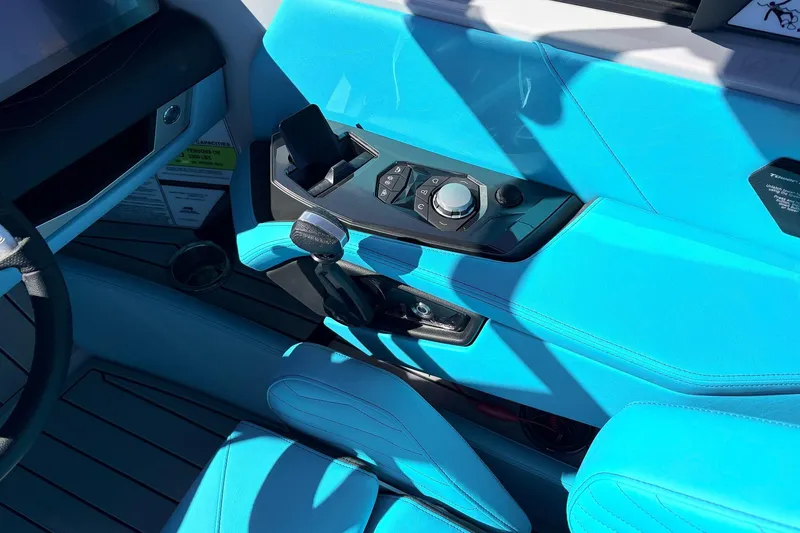 Slide: The Image of Interior of 2026 Nautique Super Air Nautique G23 with blue upholstery and control panel. - 48