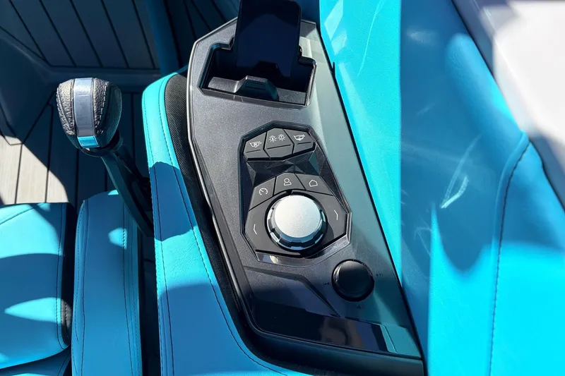 Slide: The Image of Control panel of 2026 Nautique Super Air Nautique G23 with sleek design and vibrant blue upholstery. - 49