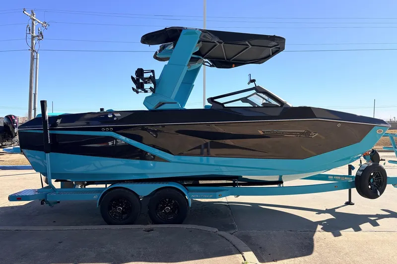 Slide: The Image of 2026 Nautique Super Air Nautique G23 boat in blue and black on a trailer. - 5