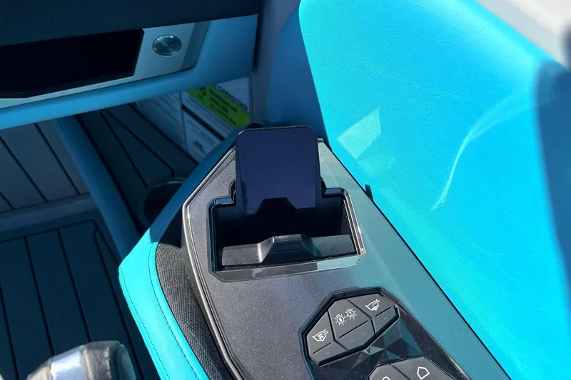 Slide: The Image of Interior of 2026 Nautique Super Air Nautique G23 with phone holder and control panel. - 50